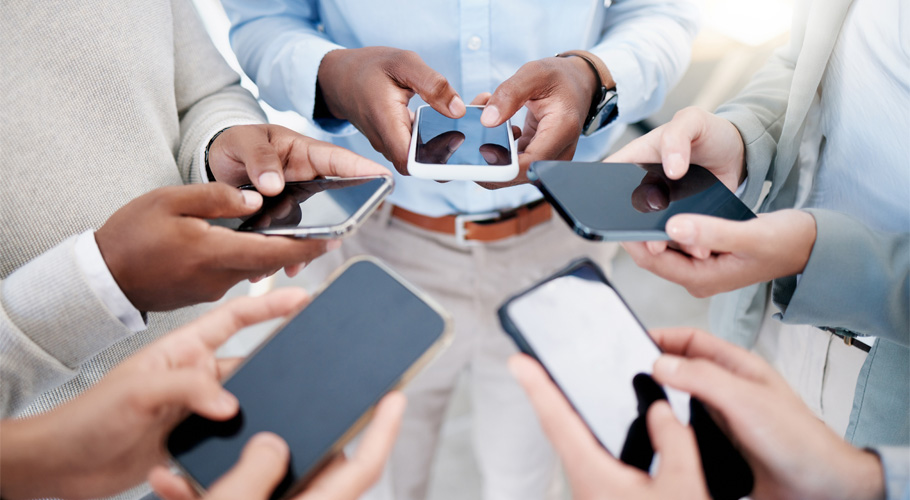 A group of people looking down at the their phones