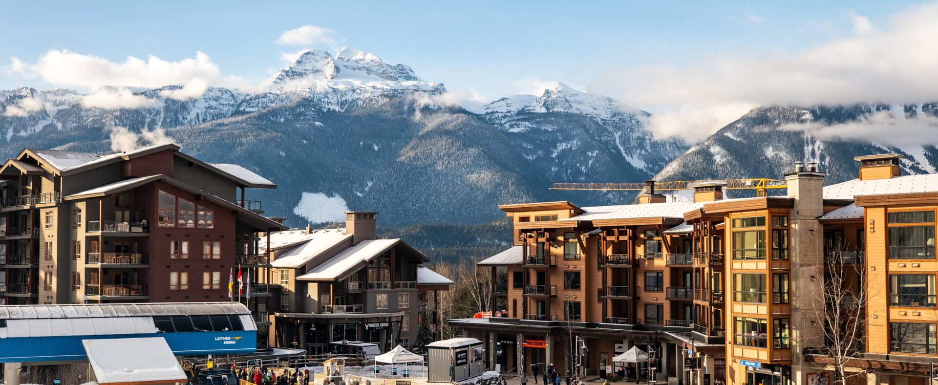 A frontal view of the revelstoke mountain resort with the mountains in the horizon in the back