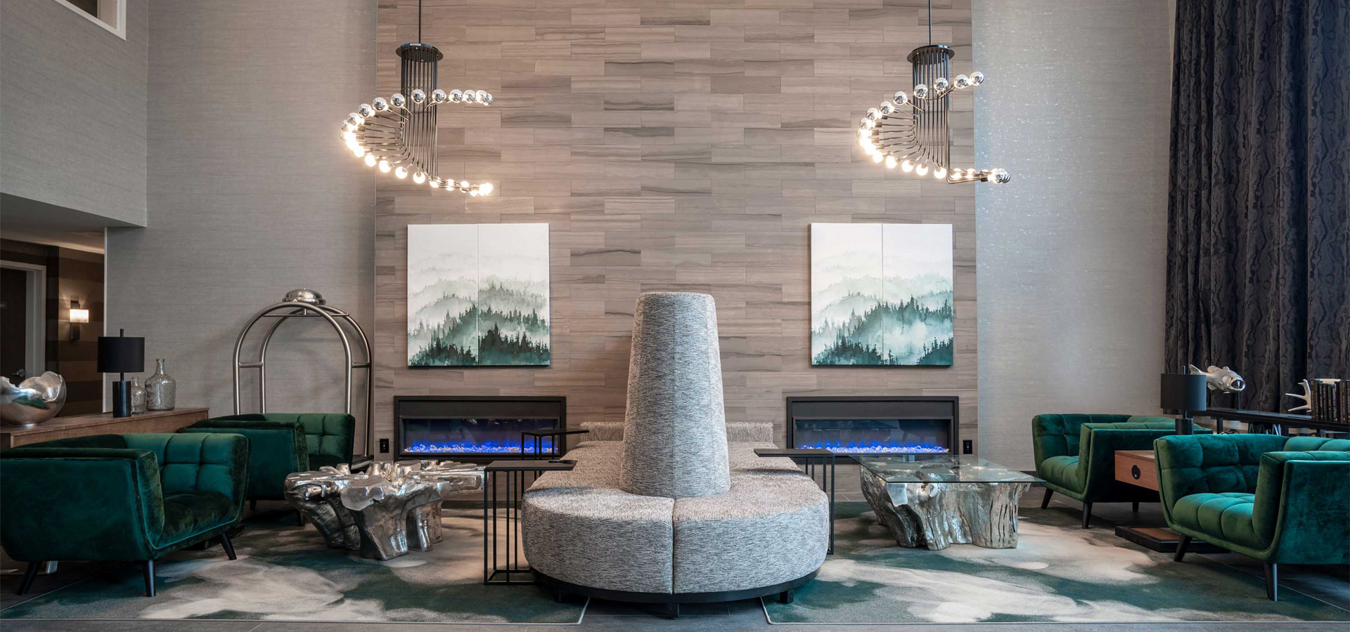 A lobby area at one of the Sandman Hotels, with a circular couch and paintings hanging on the wall